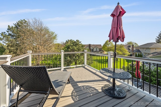 deck with a lawn and a residential view