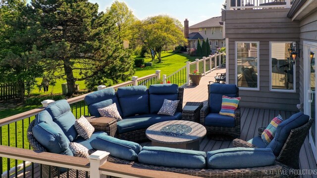 deck featuring an outdoor living space and a lawn