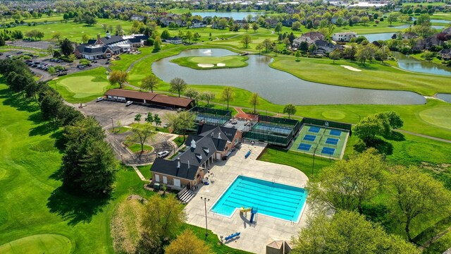 bird's eye view of a nearby body of water, a golf club, and a pool