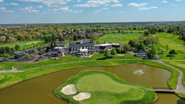 aerial view of a large body of water, a golf course, and a tree filled landscape