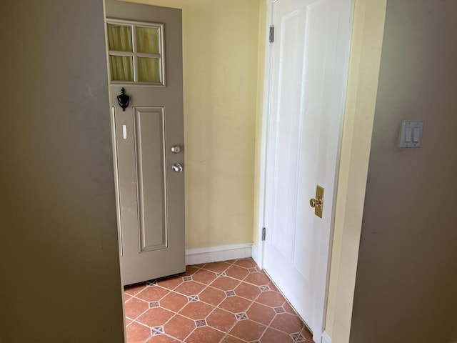 hall with dark tile patterned flooring