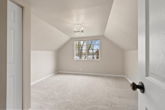 112 E Page St, Elkhorn, WI 53121 - bonus room featuring baseboards, carpet, and lofted ceiling