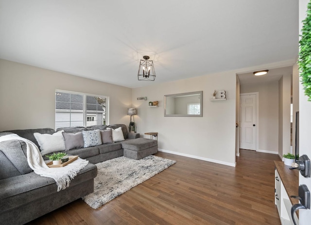 112 E Page St, Elkhorn, WI 53121 - living area featuring dark wood-style flooring, baseboards, and a chandelier