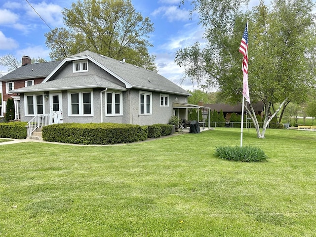 back of property with a yard and a chimney