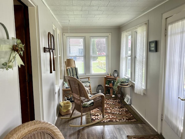 sitting room featuring ornamental molding and wood finished floors