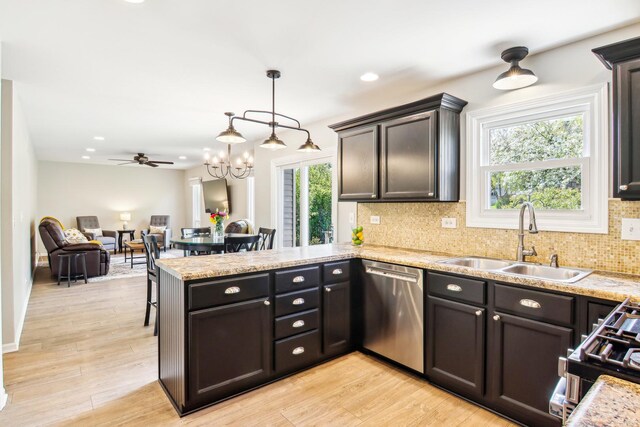 2825 Colonial Dr, Elgin, IL 60124 - kitchen with a sink, stainless steel dishwasher, a peninsula, tasteful backsplash, and a chandelier
