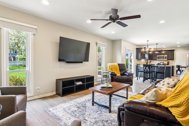 2825 Colonial Dr, Elgin, IL 60124 - living room with a ceiling fan, recessed lighting, light wood finished floors, a chandelier, and baseboards
