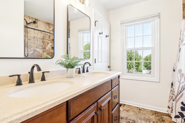 2825 Colonial Dr, Elgin, IL 60124 - full bath with double vanity and baseboards
