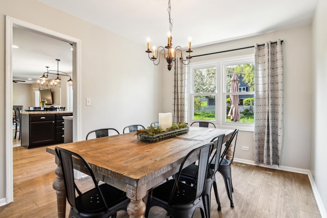 2825 Colonial Dr, Elgin, IL 60124 - dining area featuring a chandelier, light wood-style flooring, and baseboards
