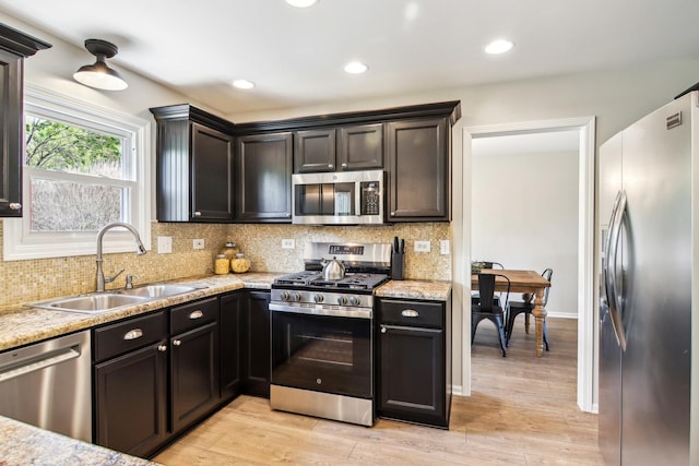 2825 Colonial Dr, Elgin, IL 60124 - kitchen with appliances with stainless steel finishes, a sink, decorative backsplash, light wood finished floors, and recessed lighting