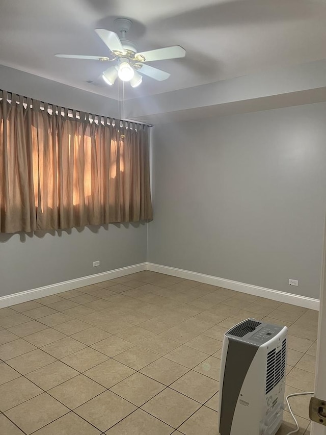 2126 N Kostner Ave, Chicago, IL 60639 - empty room with a ceiling fan, baseboards, and light tile patterned flooring