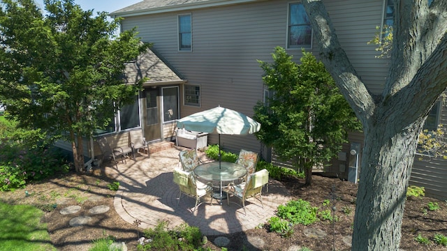 2835 Randall Ridge Ct, Elgin, IL 60124 - rear view of property featuring a patio, a sunroom, a shingled roof, and outdoor dining area