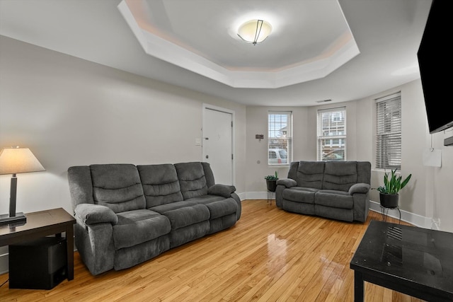 6401 23rd St Unit 2, Berwyn, IL 60402 - living room featuring light wood-style floors, a raised ceiling, and baseboards