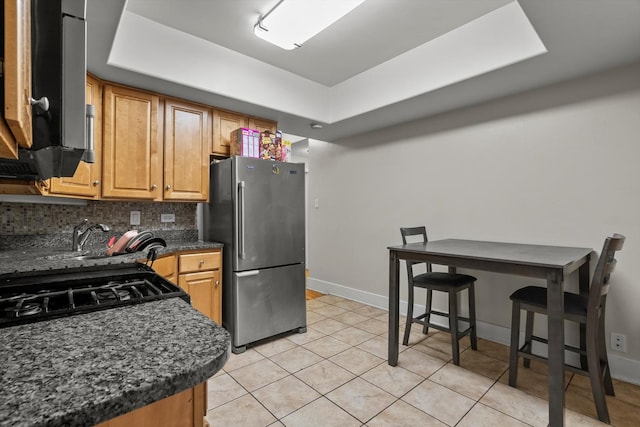 6401 23rd St Unit 2, Berwyn, IL 60402 - kitchen featuring freestanding refrigerator, decorative backsplash, baseboards, a raised ceiling, and light tile patterned floors