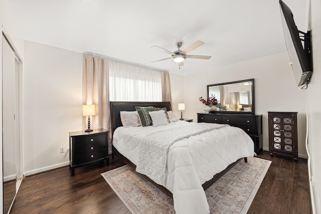 bedroom with baseboards, dark wood-type flooring, and ceiling fan