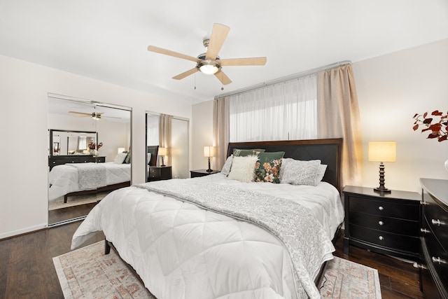 bedroom with ceiling fan, two closets, and wood finished floors