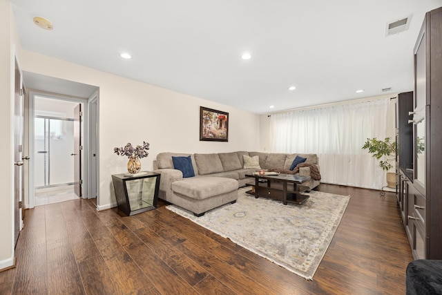 living room with visible vents, recessed lighting, and dark wood-style flooring