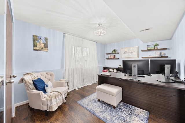 home office with an inviting chandelier, dark wood-style flooring, and visible vents