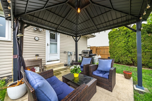 view of patio / terrace featuring fence, a gazebo, entry steps, and outdoor lounge area