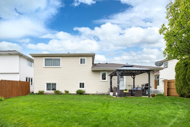 back of property featuring an outdoor living space, a lawn, fence, and a gazebo