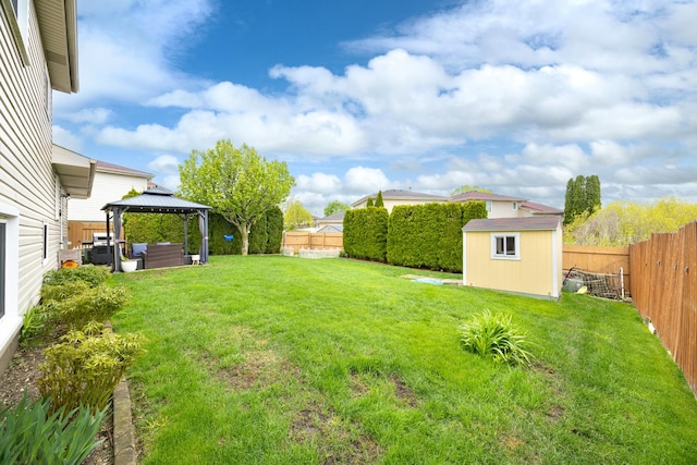 view of yard featuring an outdoor living space, a gazebo, an outdoor structure, a shed, and a fenced backyard