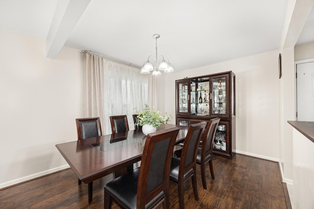 dining room featuring baseboards, a chandelier, and wood finished floors