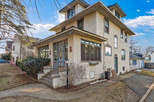 141 Park Ave, Dekalb, IL 60115 - view of property exterior featuring stucco siding and fence