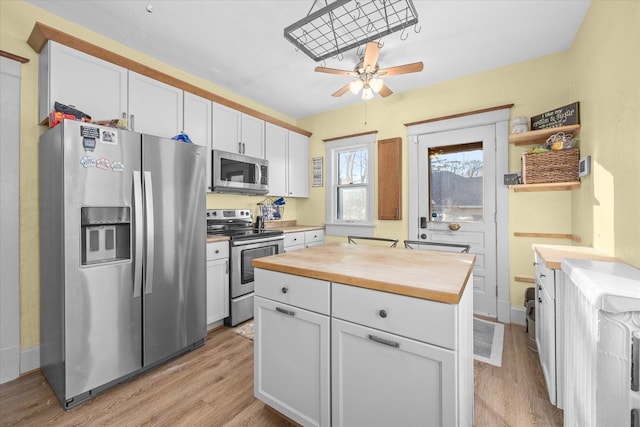 141 Park Ave, Dekalb, IL 60115 - kitchen featuring white cabinets, ceiling fan, appliances with stainless steel finishes, wooden counters, and light wood-type flooring