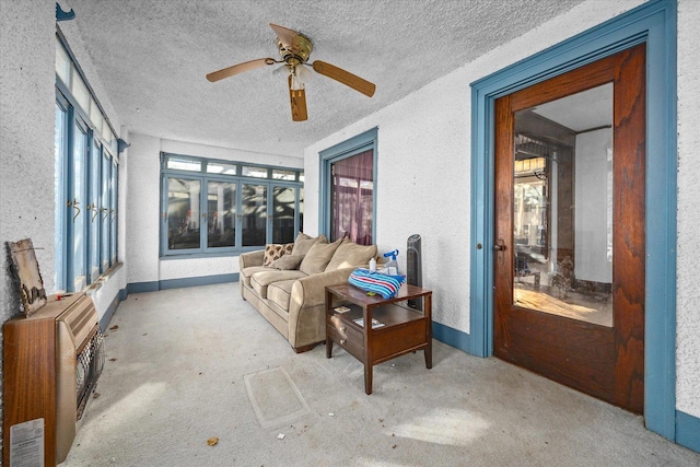 141 Park Ave, Dekalb, IL 60115 - sunroom / solarium featuring a textured ceiling, a textured wall, baseboards, and a wealth of natural light