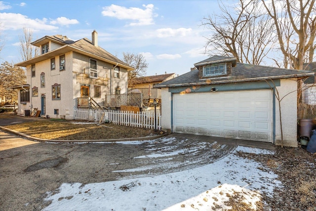 141 Park Ave, Dekalb, IL 60115 - exterior space featuring fence, an outbuilding, stucco siding, and a chimney