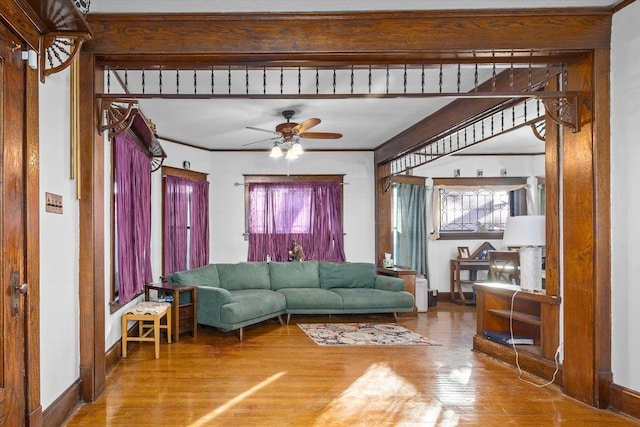141 Park Ave, Dekalb, IL 60115 - living area with baseboards, ceiling fan, ornamental molding, and wood finished floors