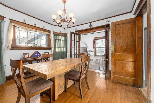 141 Park Ave, Dekalb, IL 60115 - dining space featuring crown molding, a chandelier, and wood-type flooring
