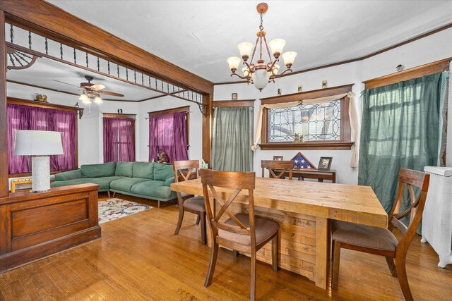 141 Park Ave, Dekalb, IL 60115 - dining area with crown molding, radiator, ceiling fan with notable chandelier, and wood finished floors