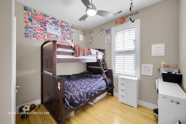 bedroom featuring baseboards, visible vents, ceiling fan, and light wood-type flooring