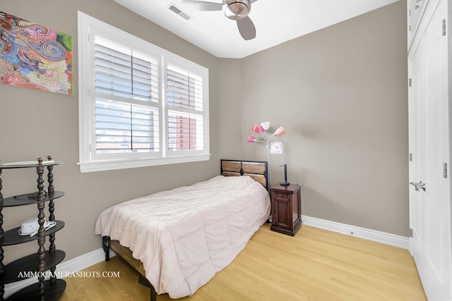 bedroom with visible vents, light wood-style flooring, baseboards, and multiple windows