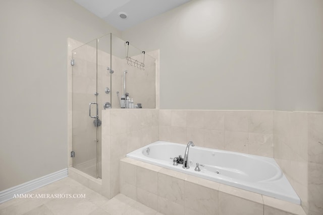 full bath featuring tile patterned flooring, a shower stall, and a bath