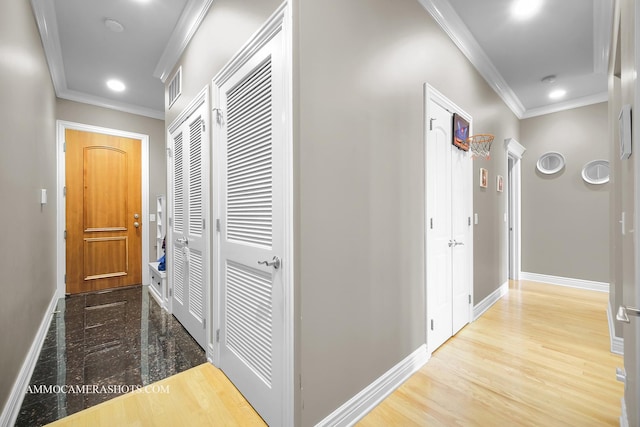 corridor with baseboards, recessed lighting, crown molding, and visible vents