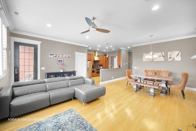 living area featuring crown molding, baseboards, ceiling fan with notable chandelier, and light wood-style flooring