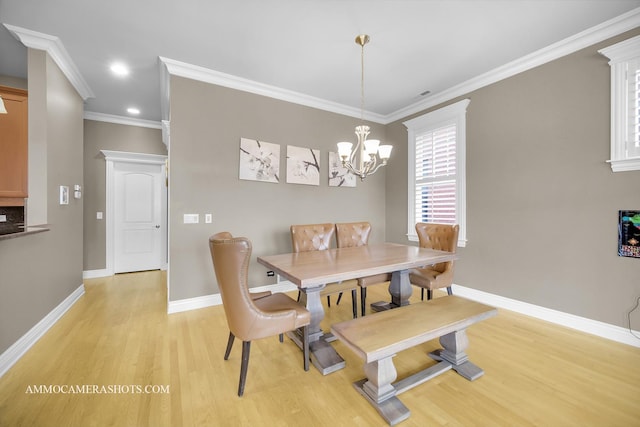 dining room featuring crown molding, baseboards, light wood-type flooring, recessed lighting, and a chandelier