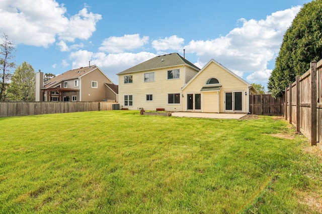 rear view of property with a lawn, a fenced backyard, a patio area, and cooling unit
