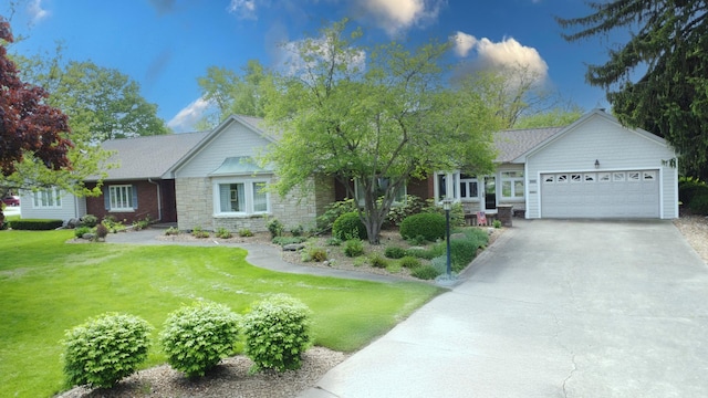single story home with stone siding, a front yard, driveway, and a garage