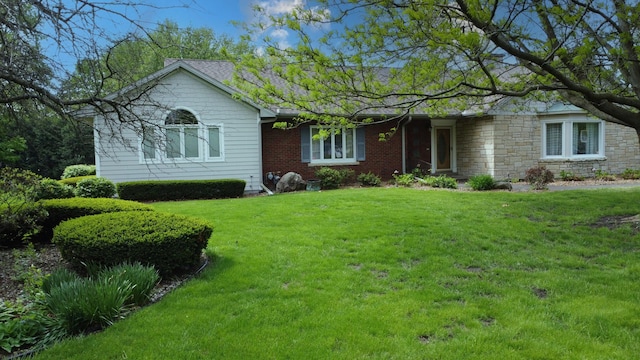 ranch-style house featuring stone siding and a front lawn