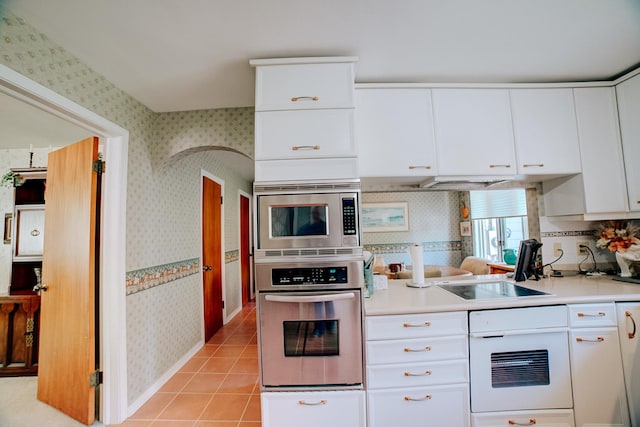 kitchen with light countertops, stainless steel appliances, and wallpapered walls