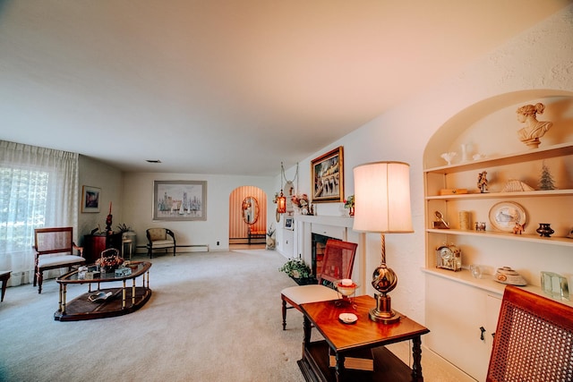 living room featuring light colored carpet, a fireplace, baseboard heating, and arched walkways