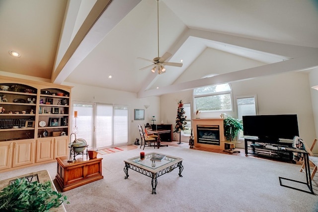 living area with a ceiling fan, recessed lighting, a fireplace with flush hearth, high vaulted ceiling, and light colored carpet