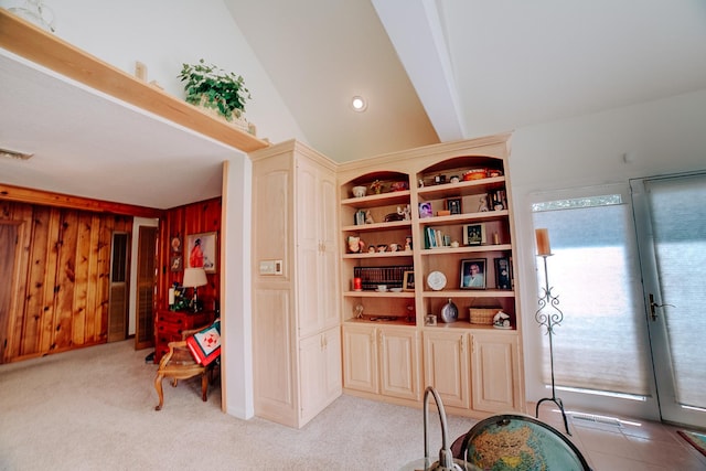 sitting room featuring light carpet, wooden walls, french doors, and visible vents