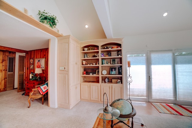 living area featuring wooden walls, plenty of natural light, and recessed lighting