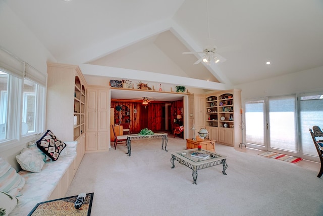 living area featuring light carpet, a ceiling fan, beamed ceiling, and high vaulted ceiling