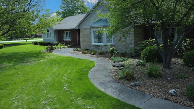 view of front of property featuring stone siding and a front yard