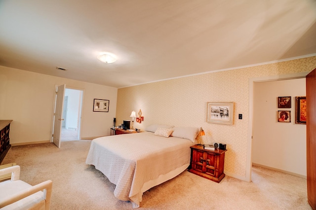 bedroom featuring ornamental molding, light carpet, baseboards, and visible vents
